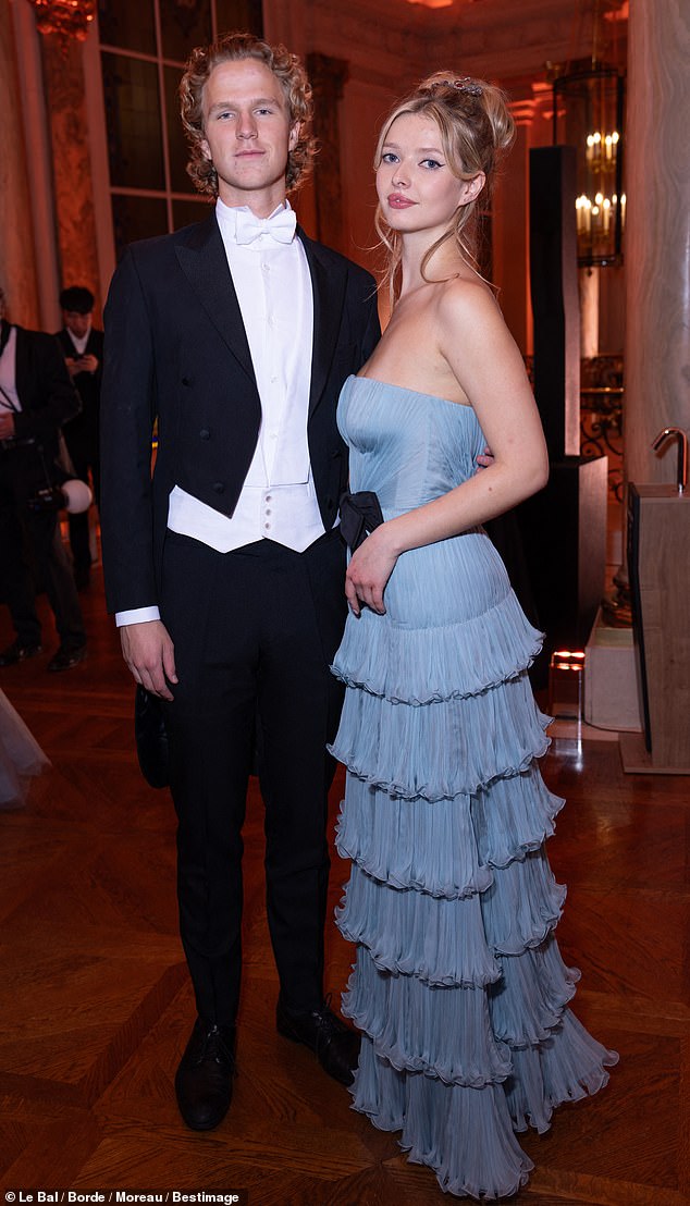 Apple, 20, the stunning model daughter of Gwyneth Paltrow and Chris Martin, attended the prestigious Le Bal des Débutantes in Paris, France on Saturday. She is seen with her date.