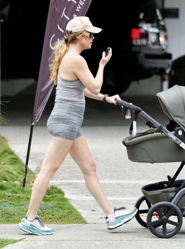 She carried her son in a stroller as she walked down the street answering a phone call and wearing designer sunglasses.