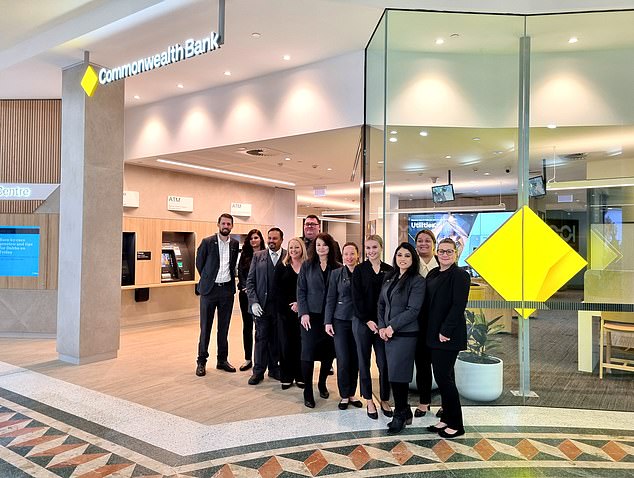 Pictured are workers at a cashless Commonwealth Bank branch in Penrith. Deposits and withdrawals can still be made through on-site ATMs.