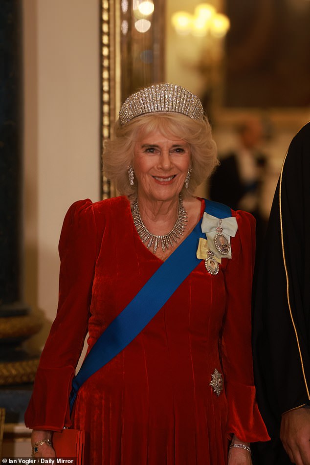 Camilla, 77, paid tribute to Queen Elizabeth II as she paired her red velvet Fiona Clare evening dress with, unusually, the diamond kokoshnik tiara belonging to the late monarch.