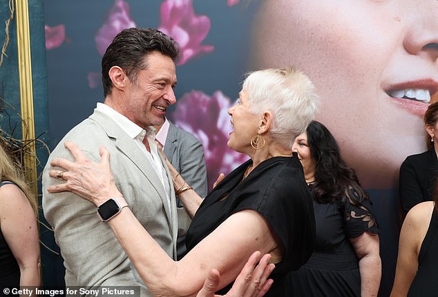 The Greatest Showman star had a 'traumatic' start in life when his own mother Grace left him as a child to start a new life in the UK. Pictured hugging Tammy Reynolds.