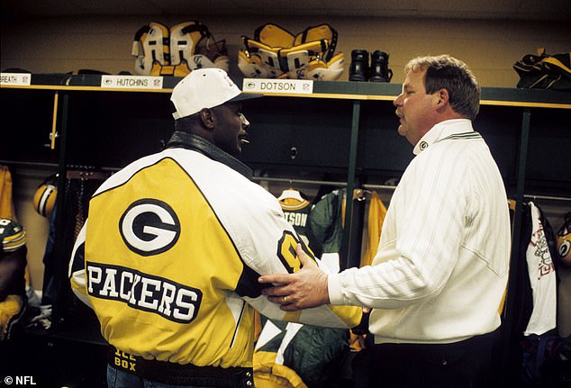 Sterling Sharpe has a conversation with Packers head coach Mike Holmgren after a 1994 playoff game