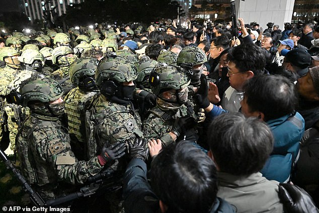 Soldiers attempt to enter the National Assembly building after Yoon Suk Yeol declares martial law