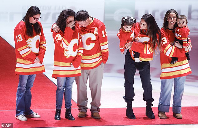 Johnny Gaudreau's family gathers at center ice before an NHL hockey game between the Calgary Flames and Columbus Blue Jackets in Calgary.