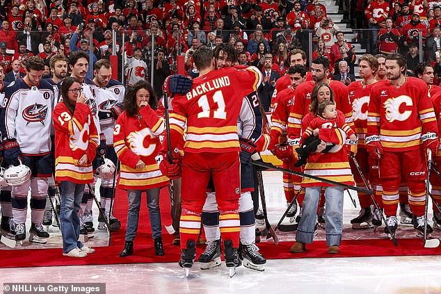 Mikael Backlund hugs former teammate and now Blue Jackets member Sean Monahan