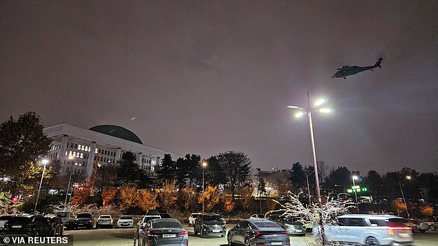 A helicopter flies over the National Assembly hall after South Korean President Yoon Suk Yeol declared martial law in Seoul, South Korea, on December 3, 2024.