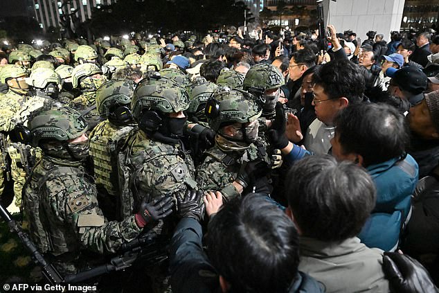 Soldiers try to enter the National Assembly building in Seoul on December 4, 2024, after South Korean President Yoon Suk Yeol declared martial law.