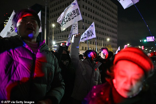 People gesture as they gather in front of the National Assembly in Seoul on Dec. 4, 2024, after South Korean President Yoon Suk Yeol declared martial law.