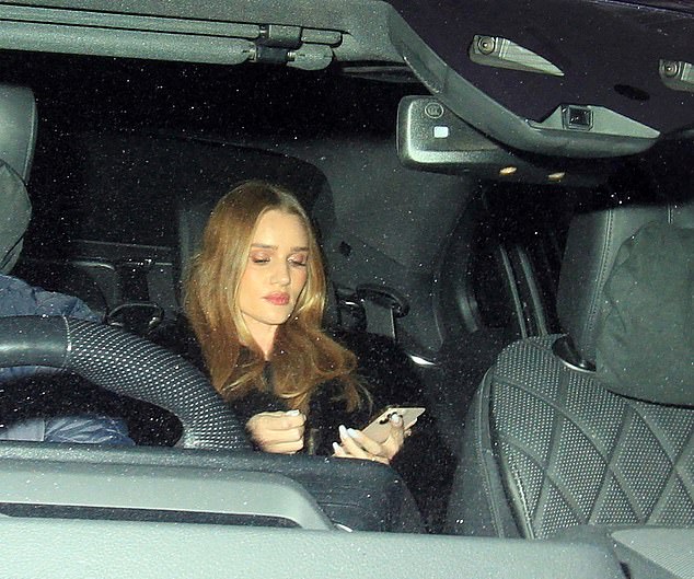 Rosie was glued to her phone as she was taken home in a taxi.