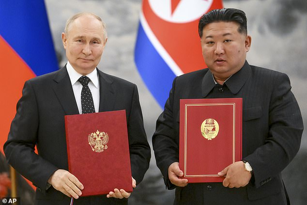 Russian President Vladimir Putin, left, and North Korean leader Kim Jong Un pose for a photo during a signing ceremony for the new partnership in Pyongyang, North Korea, June 19, 2024.