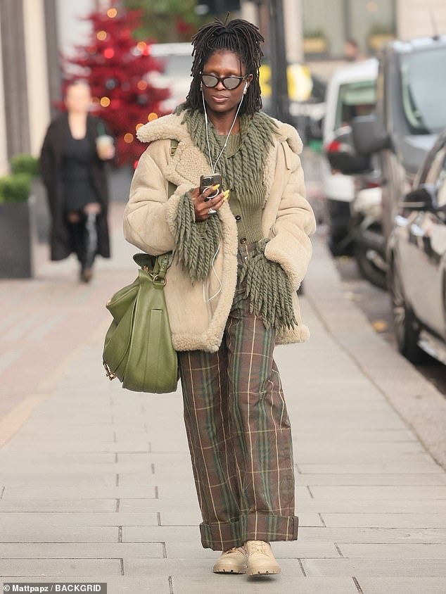 The actress looked incredible in the dress which she paired with elegant wide-leg brown and green checkered pants.