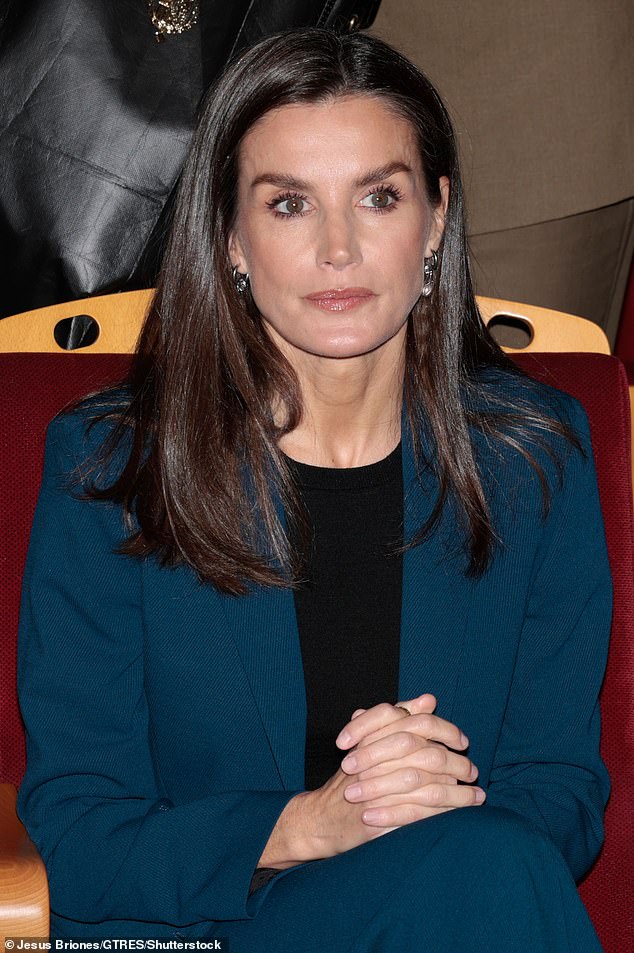 The royal wears her brunette locks down with a side part and uses thick mascara to accentuate her hazel-green eyes.