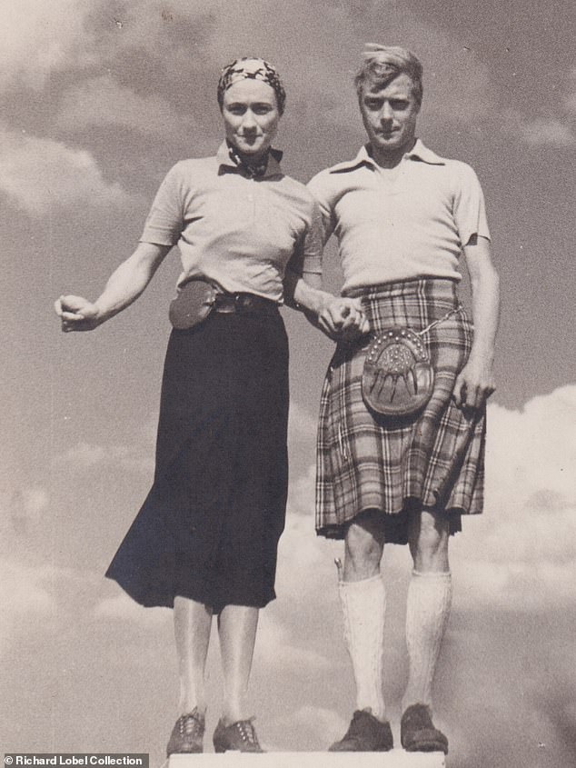 The Duke and Duchess of Windsor strike a strange and awkward pose while holding hands, summer 1937.