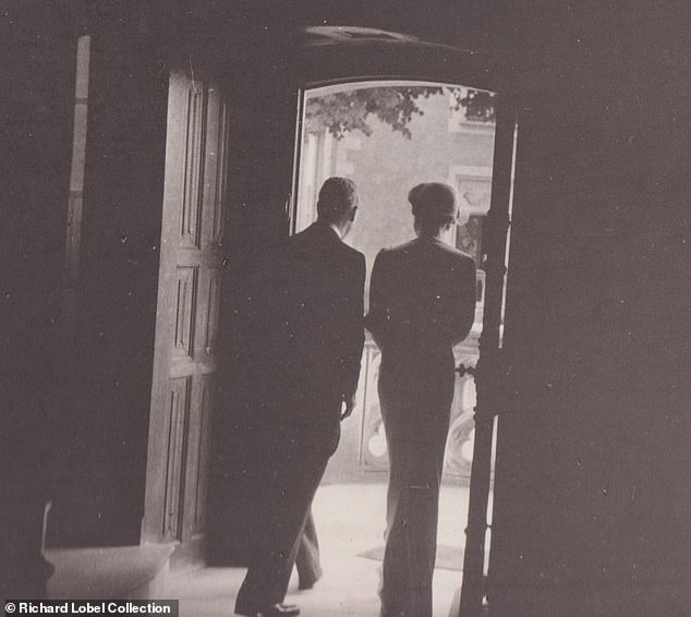 Edward and Wallis are seen leaving through a gate of the castle on their wedding day.