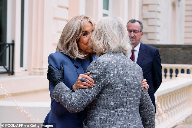 Brigitte Macron, 71, greets the Queen, 77, outside the residence of the French ambassador in London