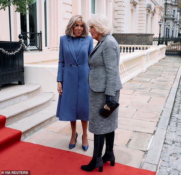 The French First Lady and the monarch talk on the red carpet before the start of the event