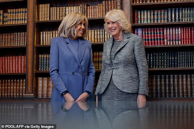 For the occasion, Queen Camilla (right) looked elegant in a speckled gray jacket and knee-length skirt.