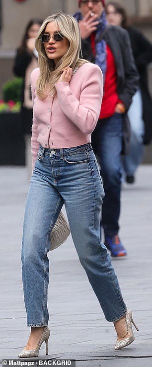 The singer finished off her look with a pair of white glitter heels, sunglasses and a matching white bag.