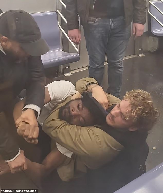 Penny grabbed Nelly in a chokehold (pictured) and wrestled him to the ground, where he restrained him for several minutes on the train after Neely threatened passengers.