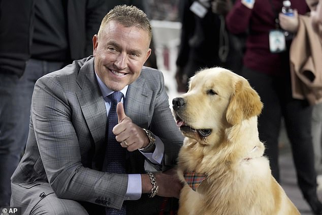 ESPN's Kirk Herbstreit, left, poses with his youngest dog, Peter, before the start of a recent game.