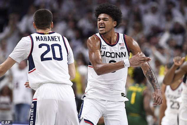 Jaylin Stewart (right) and Aidan Mahaney (left) celebrate UConn's important victory