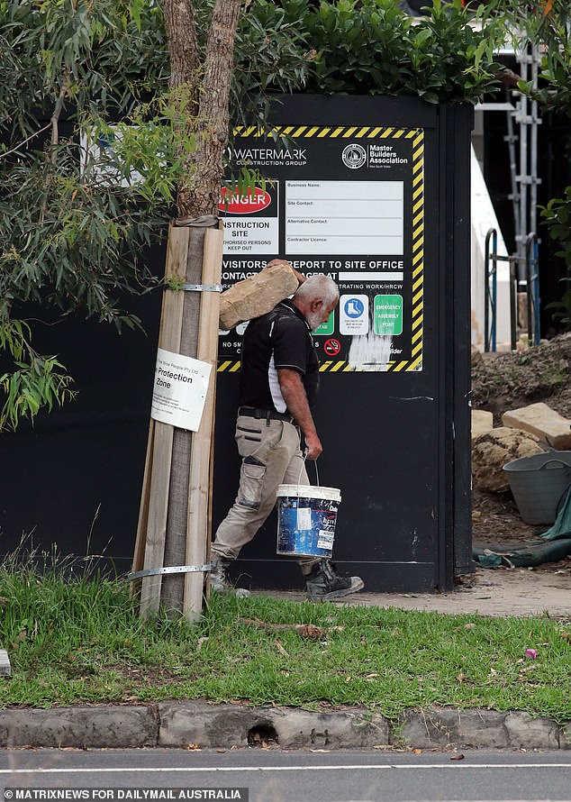 Workers transport blocks of new sandstone to complement the historic sandstone already on site