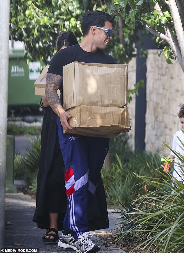 The child artist sported a casual look in a plain black T-shirt, which he paired with blue sweatpants and black Nike sneakers.