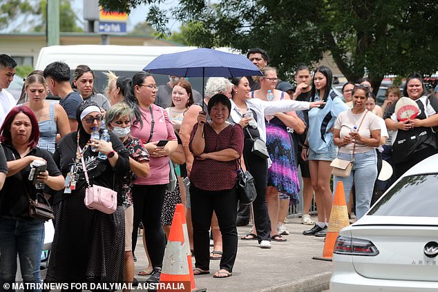 Thousands of western Sydney residents queued at 33C for a free Coles voucher on Tuesday