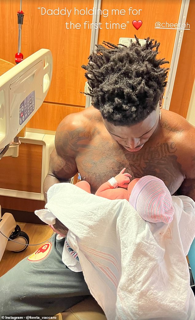 Hill holds his new daughter Capri in a photo posted by his wife Keeta Vaccaro