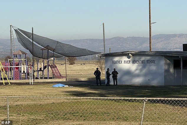 In the photo: Police stand next to the tarpaulin-covered body of the suspected gunman