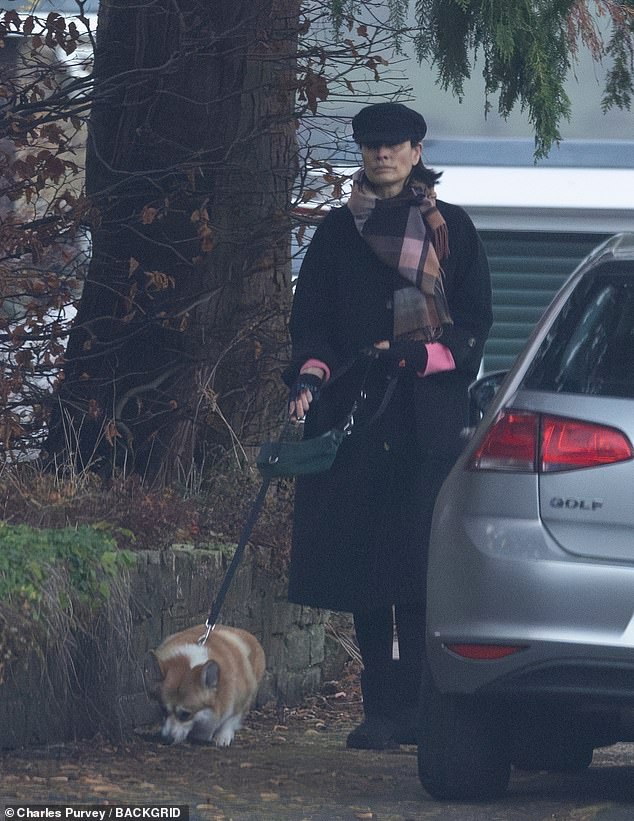 Melanie was spotted out for a walk with her dog near her home on Thursday, wrapped in a long black coat and a plaid-print scarf.