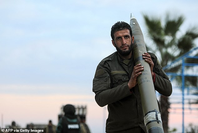 An anti-government fighter carries a rocket to be used against regime forces, on the northern outskirts of the city of Hama, in west-central Syria, on December 4, 2024.