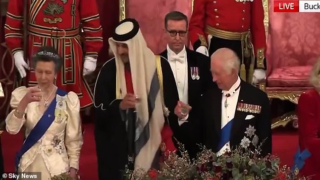 After a speech, those at the top table rose to toast, but Anne suffered an awkward moment when she appeared to go early to take a sip of her drink.