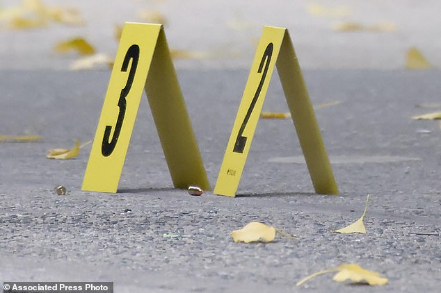 Bullets litter the sidewalk at the site outside the Hilton Hotel in downtown Manhattan where Thompson was fatally shot