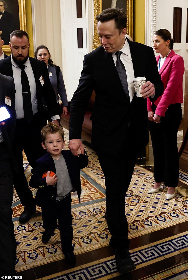 X was then seen holding his father's hand tightly as he made his way through a crowd of reporters and photographers.