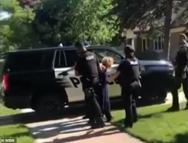 Police escorted her from her home to applause from protesters outside