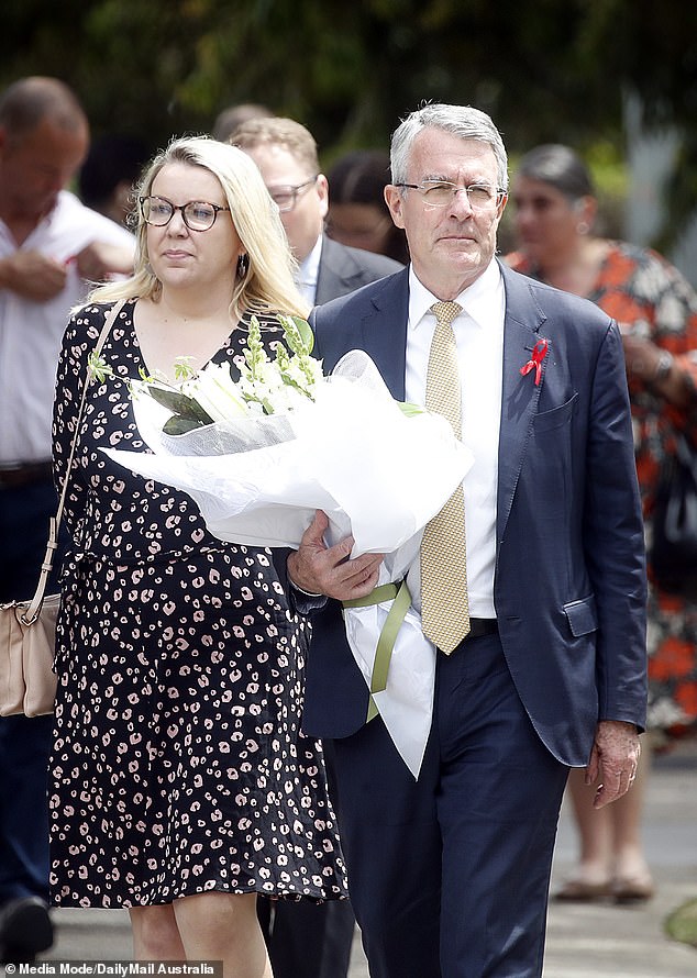 Attorney General Mark Dreyfus was photographed arriving with a large bouquet of flowers (pictured)