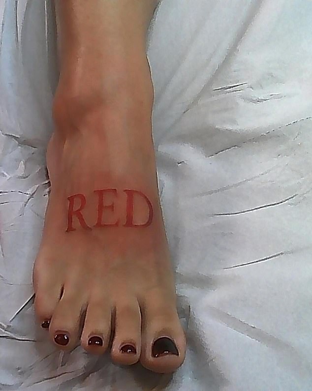 Doja's new tattoo was placed on the top of her right foot and read 