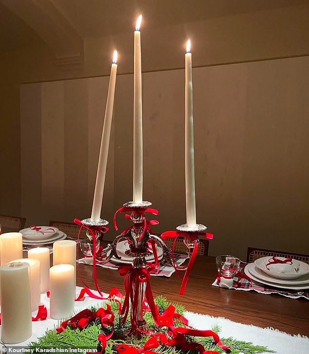 One photo she shared showed a silver candelabra adorned with festive red bows and holding three flickering candles. While two stood upright, the third leaned heavily to one side.