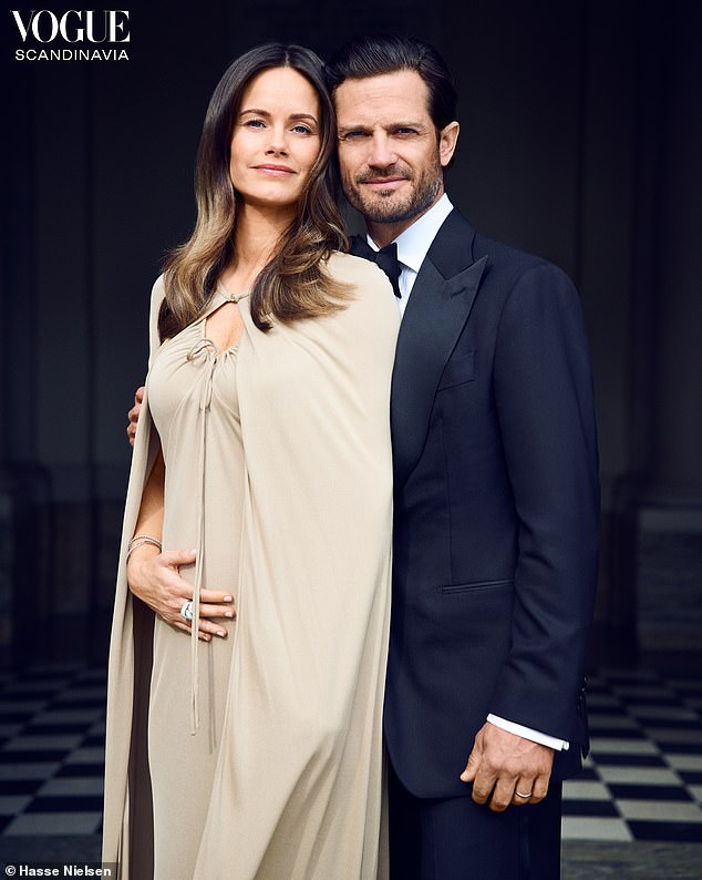 The mother-of-three cradled her baby bump as she stood proudly alongside her husband, Prince Carl Philip, 45.