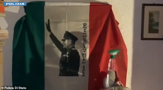 On the wall of a suspect's bedroom hangs an Italian flag depicting fascist dictator Benito Mussolini giving the Roman salute.