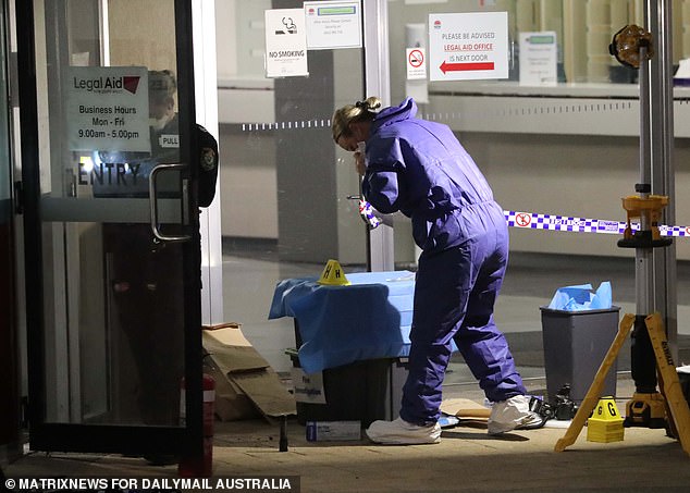 Forensics are seen combing through multiple crime scenes Thursday night.