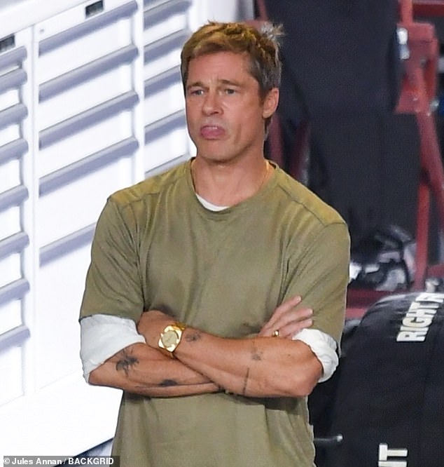 The 60-year-old star wore a short-sleeved army green T-shirt over a longer-sleeved white shirt with khaki pants. The Oscar-winning star managed to show off several tattoos on his arm.