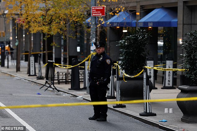 NYPD officers at the scene of the shooting near W. 54th St. and 6th Avenue. A witness said the gunman killed Thompson at close range before fleeing on a bicycle