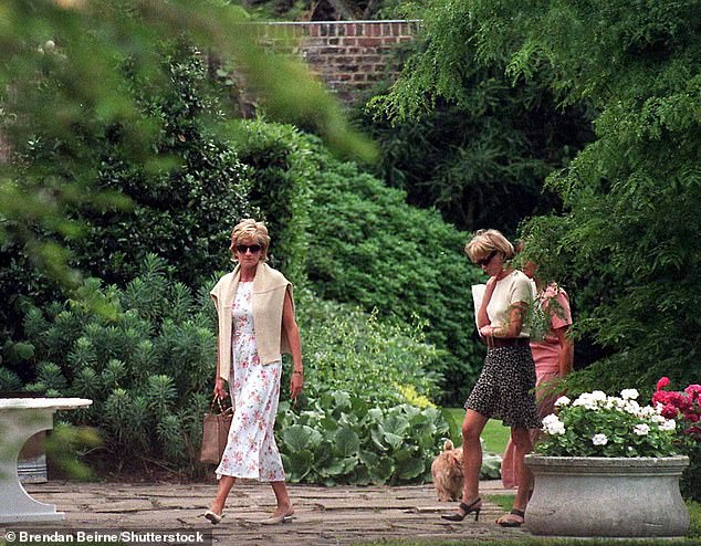 Princess Diana and Victoria Mendham walking in a garden in July 1996