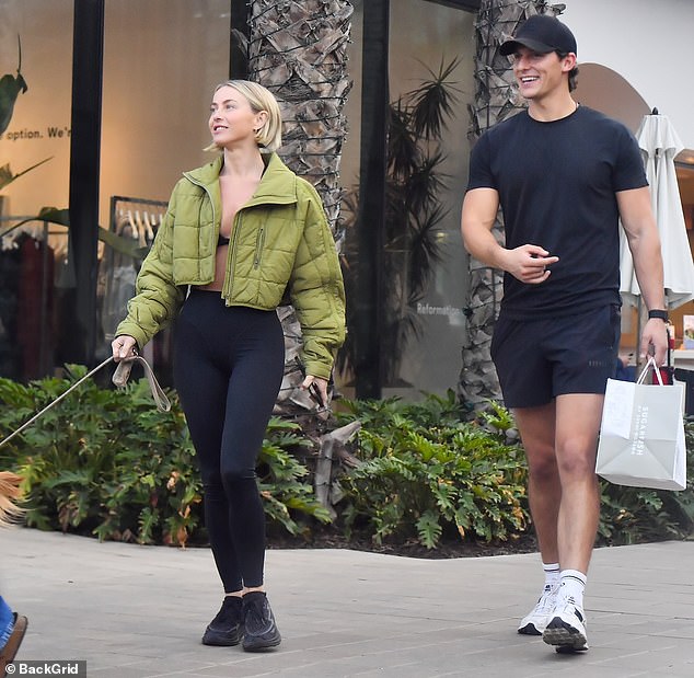 Hough showed off her toned shape wearing black leggings and a bra with black sneakers and a chartreuse jacket for warmth in the cool night air. Courtad looked stylish in a tight black T-shirt and tennis shorts.