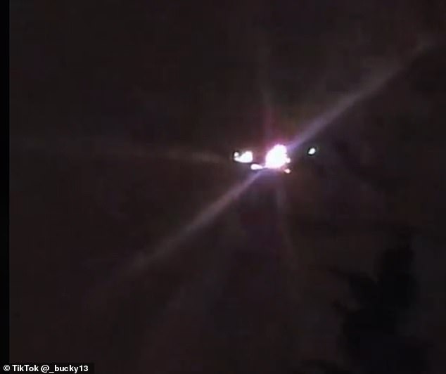 A later UFO or drone in the new video looks as if it has been hovering silently beyond the tree line, illuminated by multiple lights that pulsed brightly enough to produce a lens flare effect