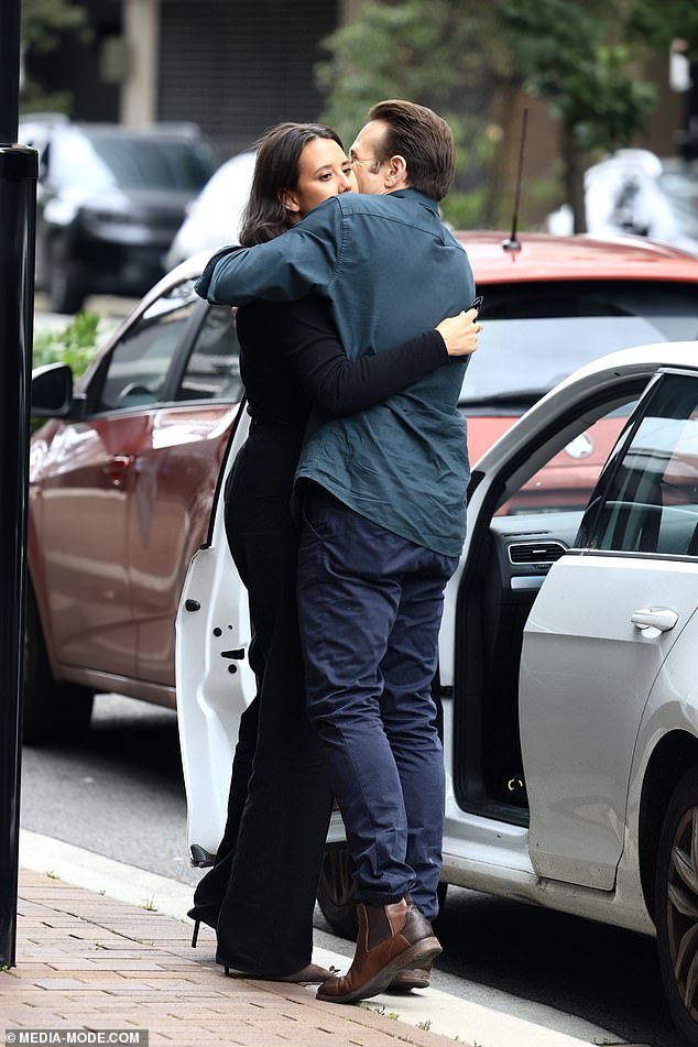 She opted for a smart-casual ensemble that included a bright green shirt and dark blue pants.