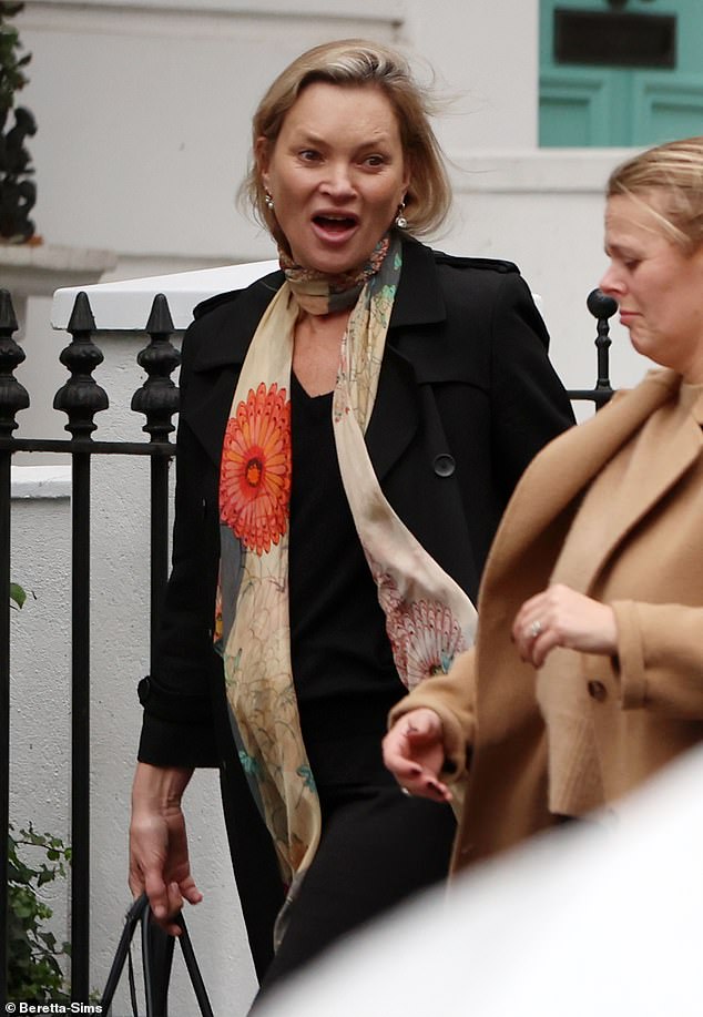 The model, 50, looked chic in a simple black coat and printed silk scarf which retails for £89.99 as she enjoyed a day out.