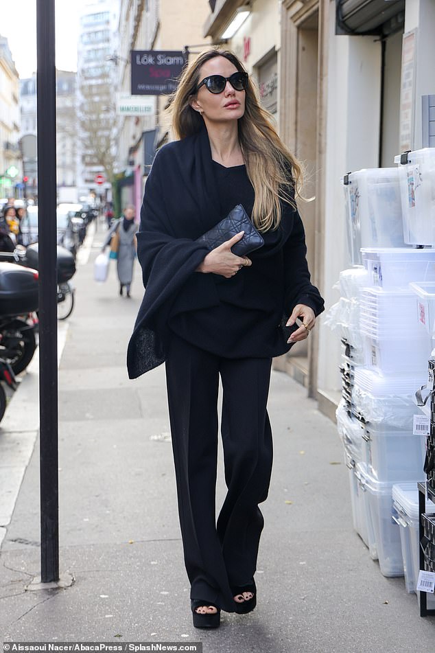 The actress, 49, who is currently in the French capital while filming her new movie Stitches, stepped out in a black wool shawl which she paired with black flared pants.